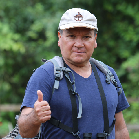 Man hiking in the jungle giving thumbs up
